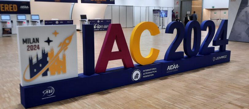 large lettering "IAC 2024" standing on a wooden floor