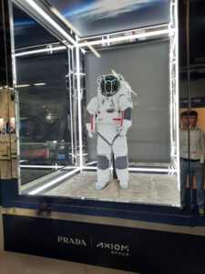 A white space suit in a chamber with glass walls